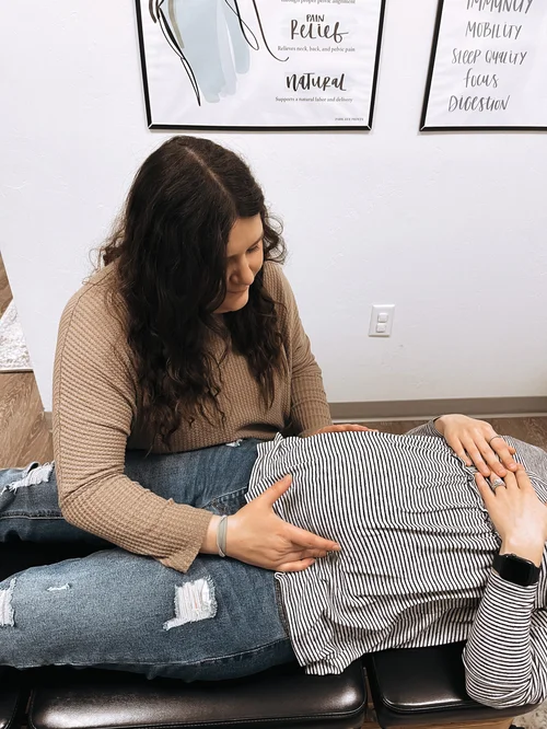 Dr. Molly Mehlman performing a prenatal chiropractic adjustment