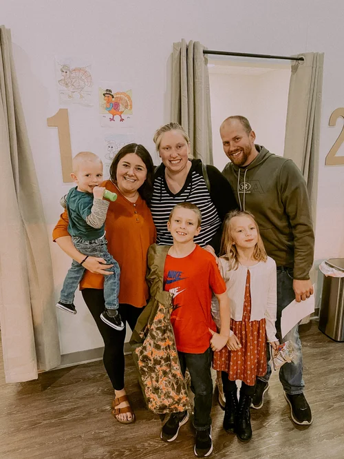 A family smiling with Dr. Molly Mehlman at Grove Chiropractic Co.