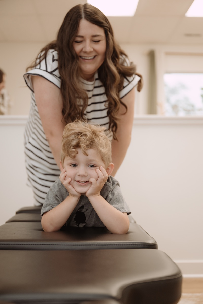 Dr. Molly Mehlman with a young child patient at Grove Chiropractic Co.